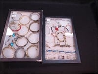 Two containers of bracelets including Greta