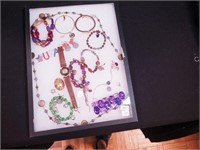 Container of costume jewelry including