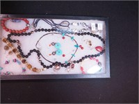 Container of beaded jewelry including onyx