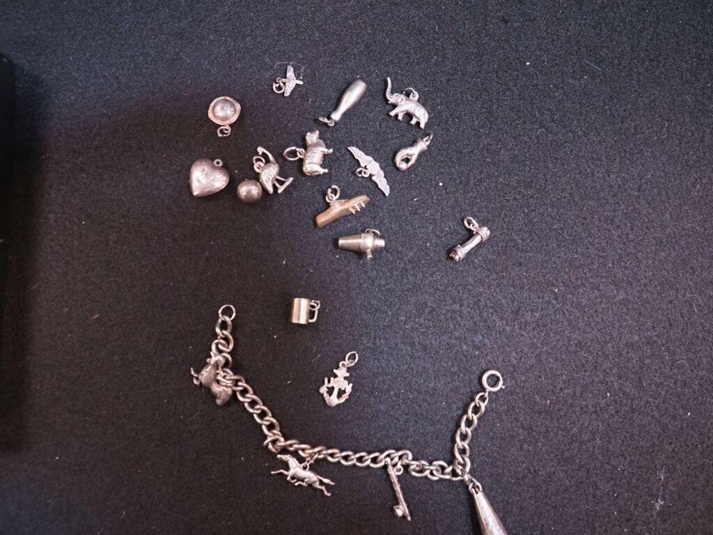 Charm bracelet with many charms, some are sterling