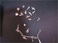 Charm bracelet with many charms, some are sterling