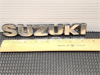 Suzuki emblem. 7.5in long