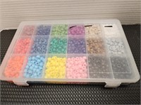 Clear case with assorted colored craft beads.