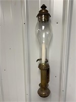 Brass candlestick wall sconce with glass globe