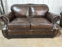 Brown leather love seat w/nailhead design