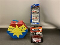 A selection of hot wheels and a marvel lunch box