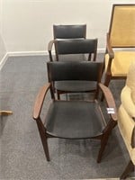 Set of three black MCM upholstered chairs