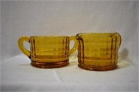 An Amber Glass Set of Cream and Sugar Container