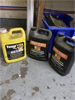Three containers antifreeze, one full two partial