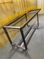 Metal cart on casters, approximately 8 foot long,