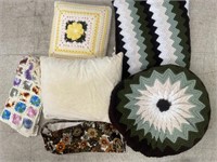 Assortment of throw pillows, Afghans, armchair