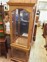 Oak lighted curio cabinet with two front doors,