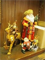 Four Christmas figurines, three are Santas from