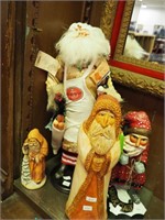 Four Santa figurines from 8" to 20", one is a
