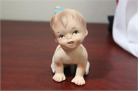 A Ceramic Baby Girl Figurine