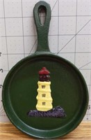 Cast iron decorative pan with lighthouse