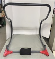 Abdominal exercise device with padded headrest.