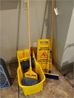 Mop bucket and caution sign