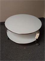 Round glass coffee table on wheels