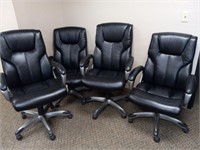 Four black office chairs