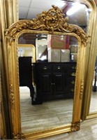 Torch and Flourish Crowned Gilt  Beveled Mirror.