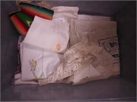Container of vintage linens including doilies,