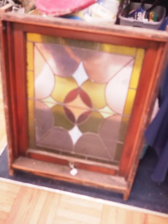 Stained glass window in frame (one pane has