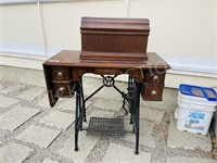 antique white treadle sewing machine in table
