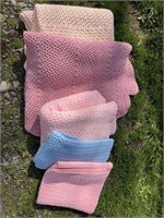 4 pink crocheted blankets and 1 blue - peach/pink