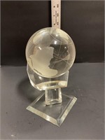 Decorative glass globe on pedestal