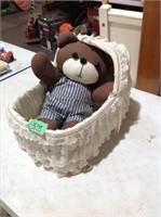 Teddy bear in doll cradle