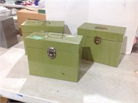 Three green metal file boxes