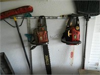 Chainsaws & Brooms Hanging on Wall