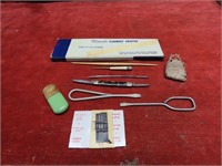 Pocket knife, needle case, sewing related items.