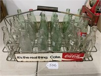24 Coke bottles in metal Coke carrier