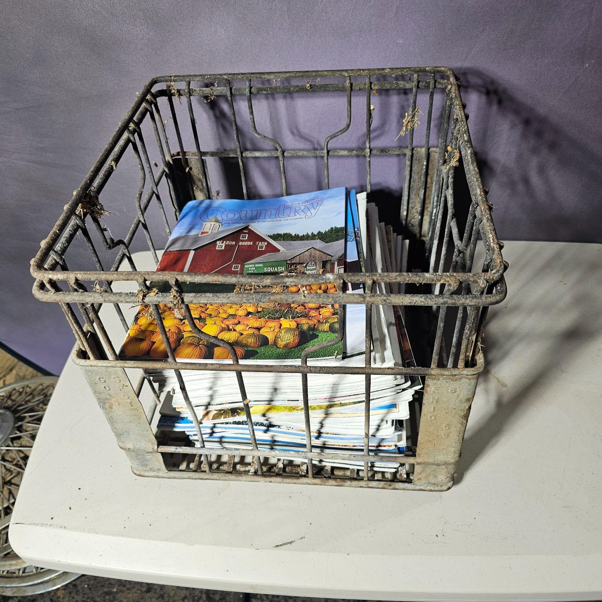 Metal milk crate of magazines