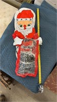 Vintage inflatable Santa holding a bag for gifts
