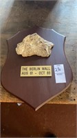 Piece of the Berlin Wall on wooden plaque. Dated