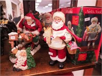 Four Santa figurines, two with boxes