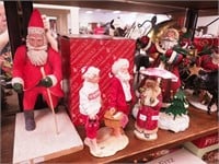 Four Christmas figurines, all depicting