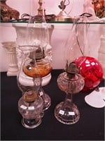 Three early American pressed glass oil lamps,