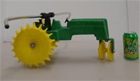 Iron and plastic green tractor traveling lawn