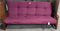 WOOD AND METAL RED-CUSHIONED FUTON