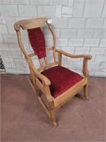 Antique rocking chair with red seat