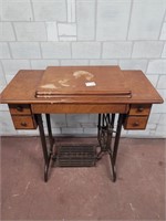 Vintage singer sewing machine with peddle table