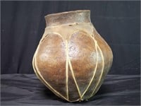 Vintage Native American pottery with hide binding