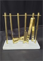 Brass bar tool set on a marble base