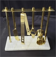 Brass bar tool set on a marble base