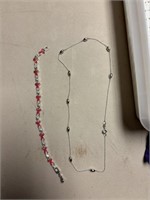 breast cancer bracelet and silver necklace
