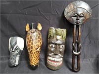 Group of carved wood mask decorations